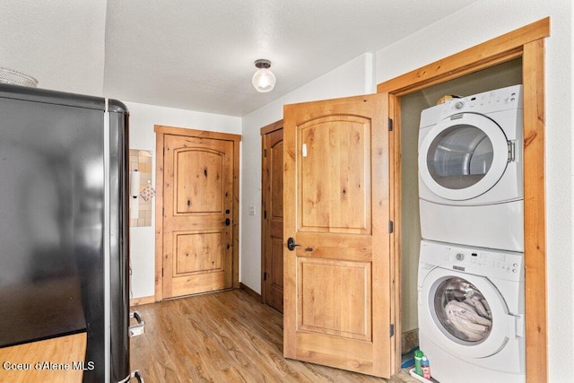 4987 S Bay Pointe Way, Coeur Dalene, ID 83814 - washroom featuring estacked washer and dryer and light wood finished floors