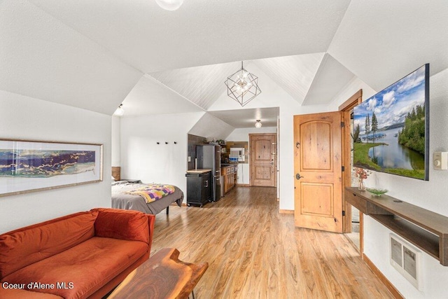 4987 S Bay Pointe Way, Coeur Dalene, ID 83814 - living area featuring light wood-style flooring and vaulted ceiling