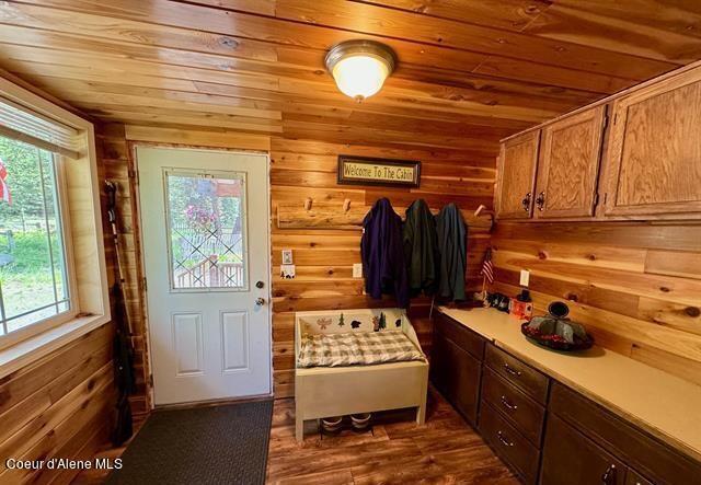22767 Spruce Ln, Lewiston, ID 83501 - mudroom with wood ceiling, plenty of natural light, wood walls, and dark wood-type flooring