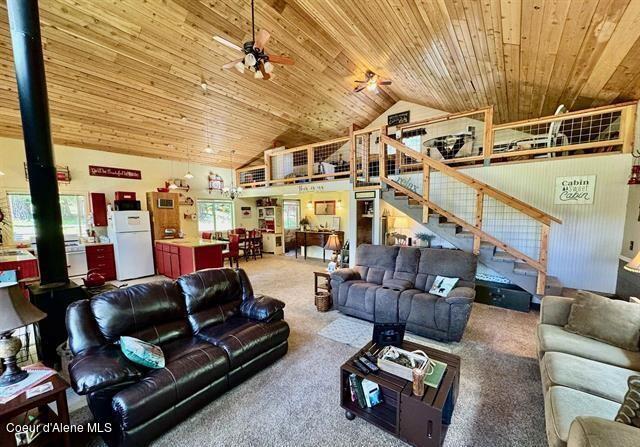 22767 Spruce Ln, Lewiston, ID 83501 - living area with carpet, a ceiling fan, wood ceiling, stairway, and high vaulted ceiling