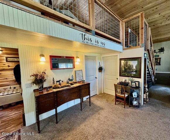 22767 Spruce Ln, Lewiston, ID 83501 - living room featuring high vaulted ceiling, carpet flooring, and stairs