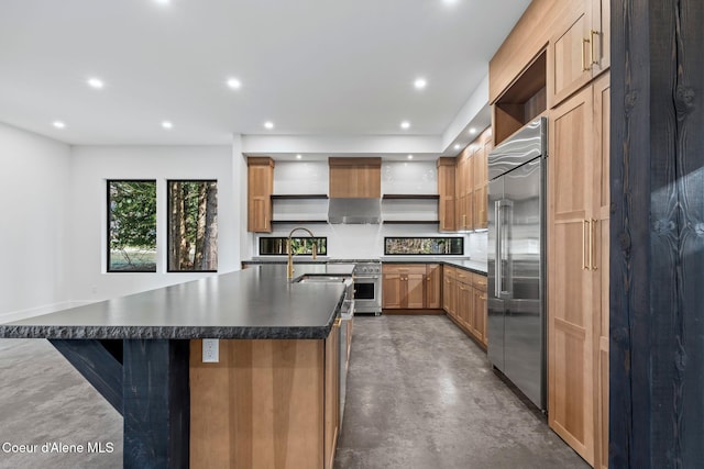 541 N Idaho Club Dr, Sandpoint, ID 83864 - kitchen featuring open shelves, high end appliances, dark countertops, finished concrete floors, and a sink