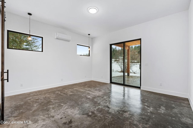 541 N Idaho Club Dr, Sandpoint, ID 83864 - empty room featuring finished concrete floors, a wall unit AC, and baseboards