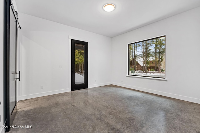 541 N Idaho Club Dr, Sandpoint, ID 83864 - spare room featuring finished concrete flooring and baseboards
