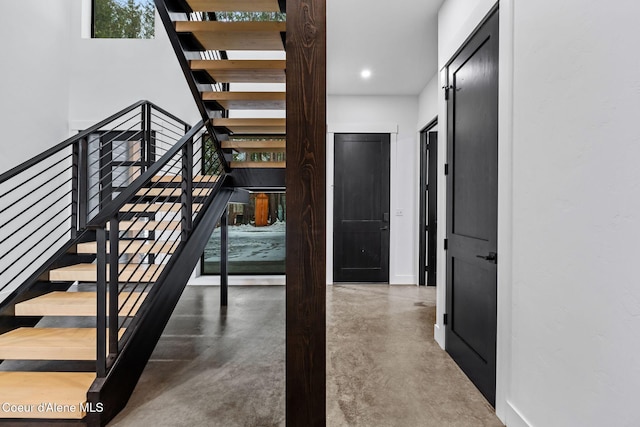 541 N Idaho Club Dr, Sandpoint, ID 83864 - stairway with concrete flooring, baseboards, and recessed lighting