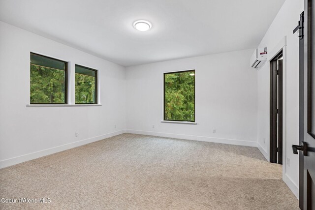 541 N Idaho Club Dr, Sandpoint, ID 83864 - unfurnished room featuring plenty of natural light, a wall mounted AC, and light colored carpet