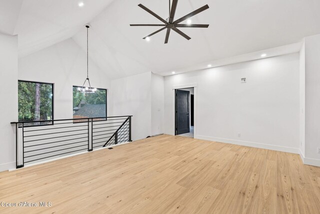 541 N Idaho Club Dr, Sandpoint, ID 83864 - unfurnished living room featuring high vaulted ceiling, recessed lighting, wood finished floors, baseboards, and a ceiling fan