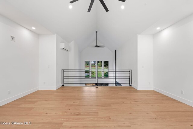 541 N Idaho Club Dr, Sandpoint, ID 83864 - empty room featuring ceiling fan, a wall mounted air conditioner, recessed lighting, light wood-type flooring, and vaulted ceiling
