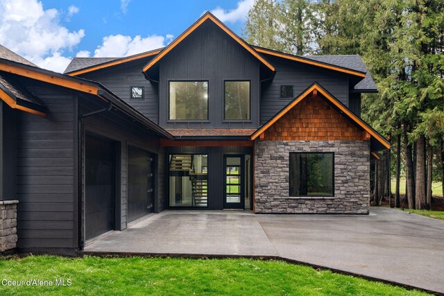 541 N Idaho Club Dr, Sandpoint, ID 83864 - rear view of house with stone siding and board and batten siding