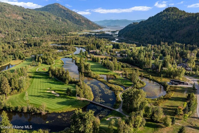 541 N Idaho Club Dr, Sandpoint, ID 83864 - mountain view with a nearby body of water, a heavily wooded area, and a local golf course