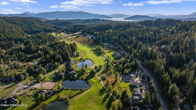 541 N Idaho Club Dr, Sandpoint, ID 83864 - aerial view of property and surrounding area featuring a heavily wooded area, a water and mountain view, and a local golf course