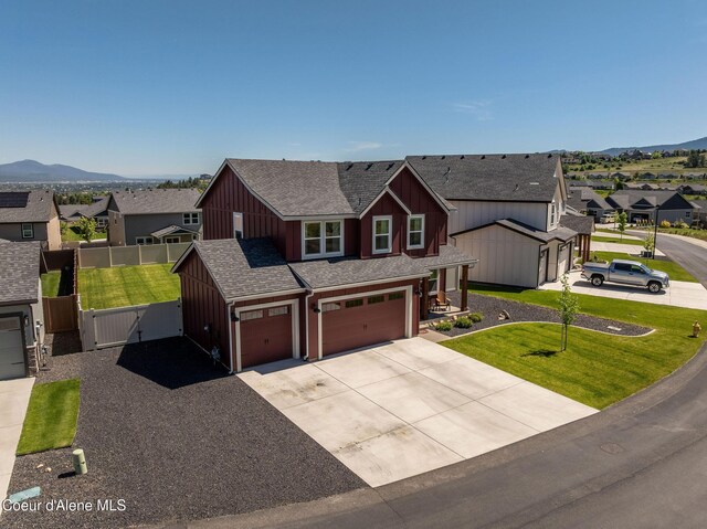 21367 E Acadia Ct, Liberty Lake, WA 99019 - view of front facade with a residential view, roof with shingles, board and batten siding, driveway, and a mountain view
