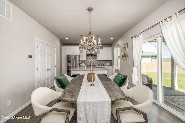 21367 E Acadia Ct, Liberty Lake, WA 99019 - dining area featuring a chandelier, dark wood finished floors, recessed lighting, and baseboards