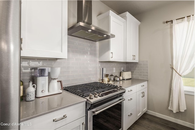 21367 E Acadia Ct, Liberty Lake, WA 99019 - kitchen with stainless steel gas range oven, wall chimney exhaust hood, white cabinetry, backsplash, and dark wood-style flooring