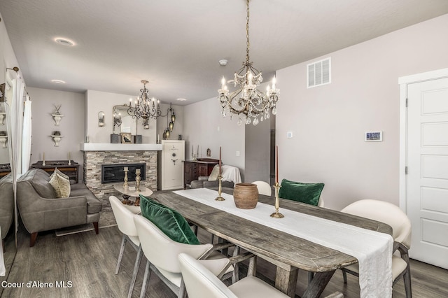 21367 E Acadia Ct, Liberty Lake, WA 99019 - dining space with a chandelier, dark wood finished floors, and a fireplace