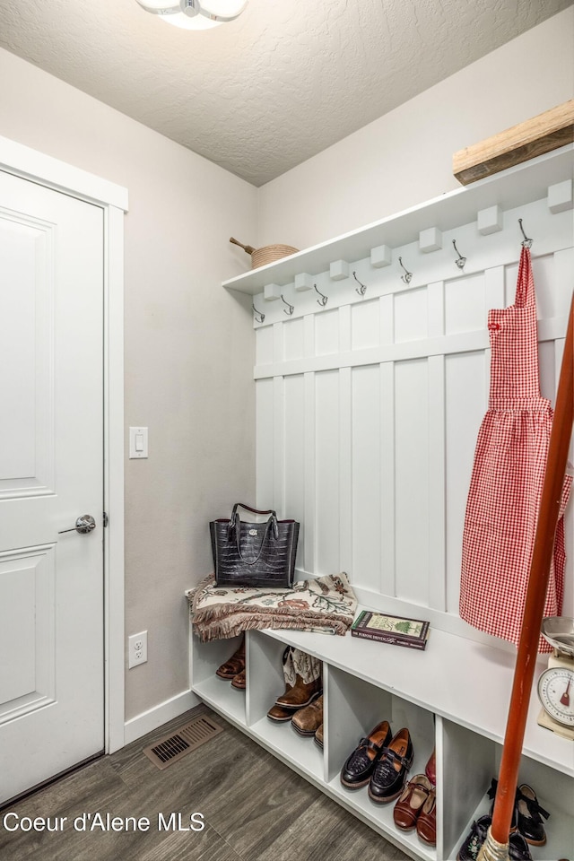 21367 E Acadia Ct, Liberty Lake, WA 99019 - mudroom with dark wood-style floors, baseboards, and a textured ceiling