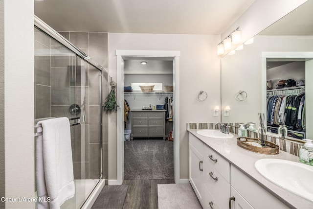 21367 E Acadia Ct, Liberty Lake, WA 99019 - full bathroom with a spacious closet, double vanity, a stall shower, and wood finished floors