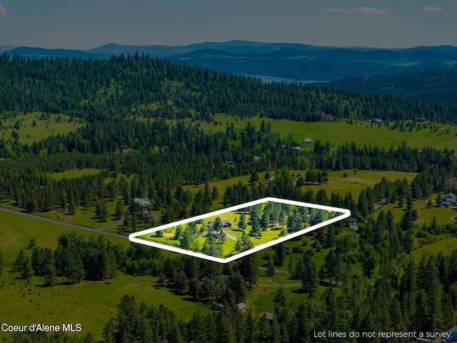 15268 S Potter Rd, Coeur Dalene, ID 83814 - aerial view of property's location featuring a heavily wooded area, a mountainous background, and property boundaries highlighted