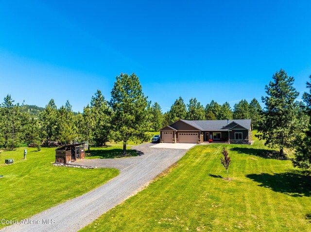 15268 S Potter Rd, Coeur Dalene, ID 83814 - view of front of house with an attached garage, driveway, and a front yard