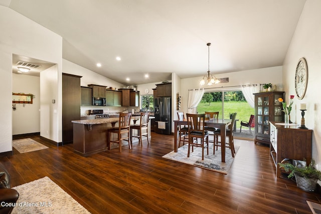 15268 S Potter Rd, Coeur Dalene, ID 83814 - dining area featuring vaulted ceiling, a chandelier, dark wood-style floors, and recessed lighting