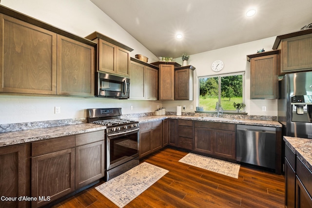 15268 S Potter Rd, Coeur Dalene, ID 83814 - kitchen with appliances with stainless steel finishes, a sink, lofted ceiling, dark wood-style floors, and light stone counters