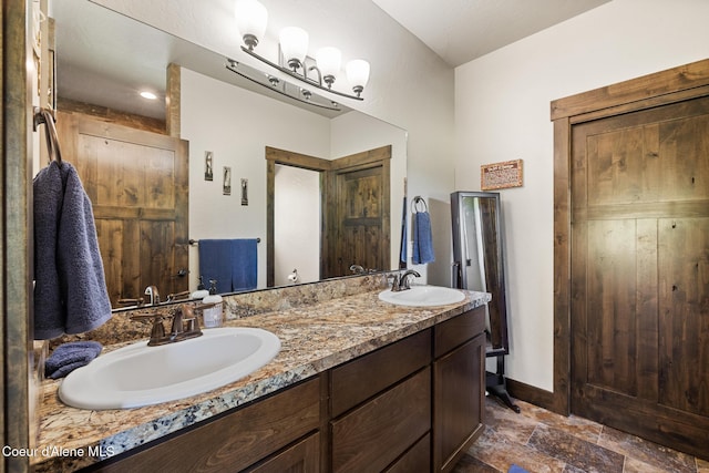 15268 S Potter Rd, Coeur Dalene, ID 83814 - bathroom featuring double vanity, stone finish floors, and baseboards