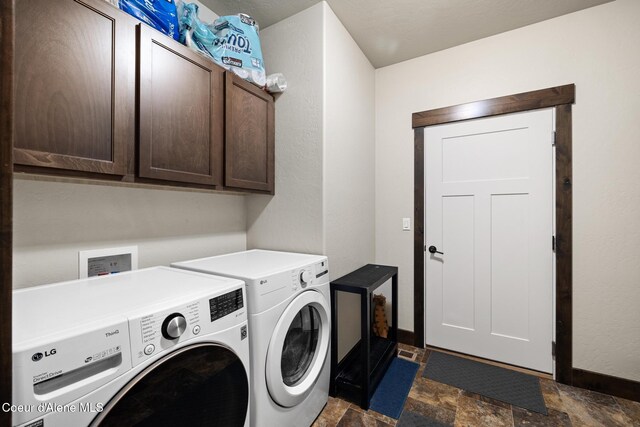15268 S Potter Rd, Coeur Dalene, ID 83814 - laundry area with washing machine and dryer, stone finish floors, cabinet space, and baseboards