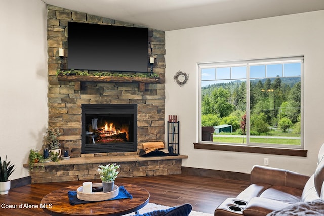 15268 S Potter Rd, Coeur Dalene, ID 83814 - living area with wood finished floors, a stone fireplace, baseboards, and lofted ceiling