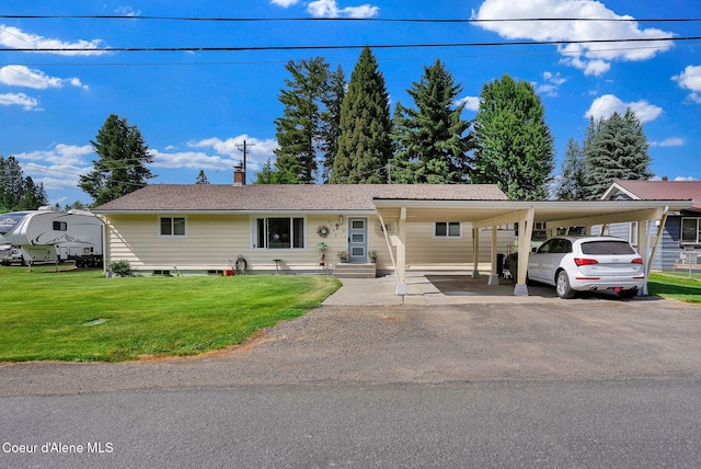 2040 Washington Ave, Saint Maries, ID 83861 - view of front facade featuring an attached carport, a front yard, a chimney, and driveway