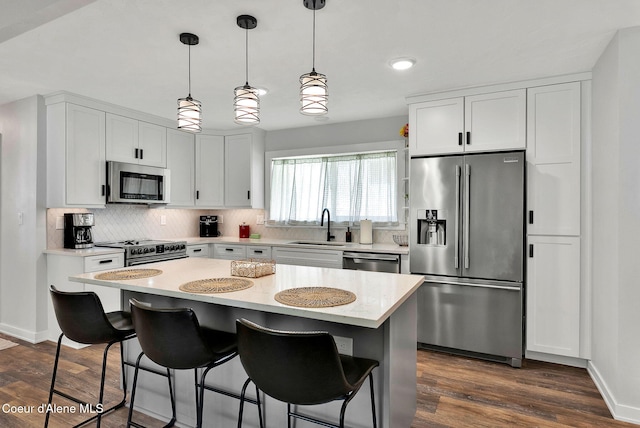 2040 Washington Ave, Saint Maries, ID 83861 - kitchen featuring appliances with stainless steel finishes, decorative backsplash, a kitchen bar, white cabinets, and recessed lighting