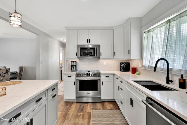 2040 Washington Ave, Saint Maries, ID 83861 - kitchen with stainless steel appliances, dark wood-style flooring, tasteful backsplash, and light stone counters