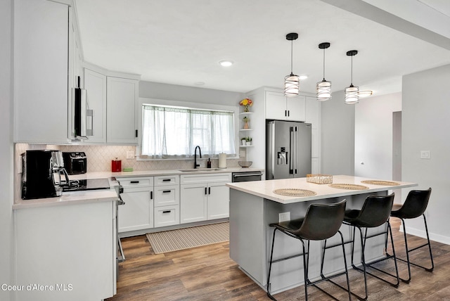 2040 Washington Ave, Saint Maries, ID 83861 - kitchen with appliances with stainless steel finishes, backsplash, a breakfast bar, light countertops, and white cabinetry