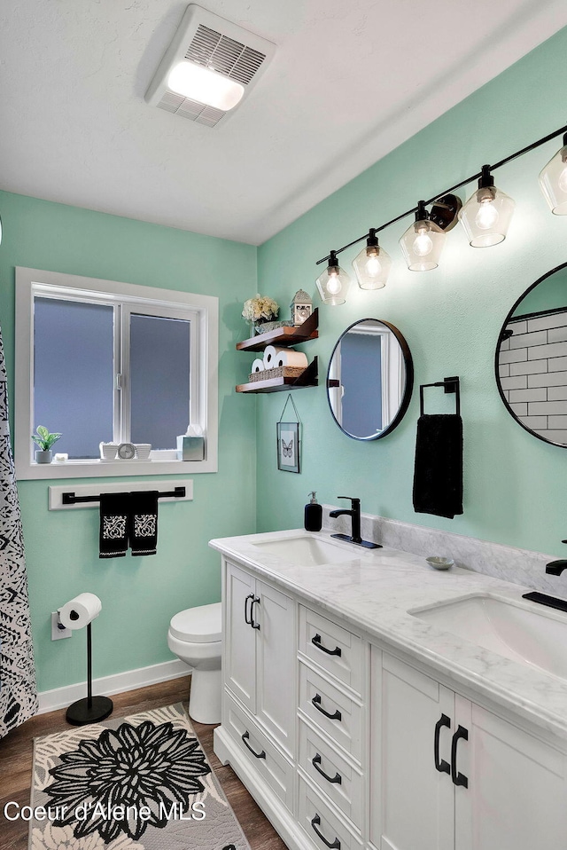 2040 Washington Ave, Saint Maries, ID 83861 - bathroom featuring wood finished floors and double vanity