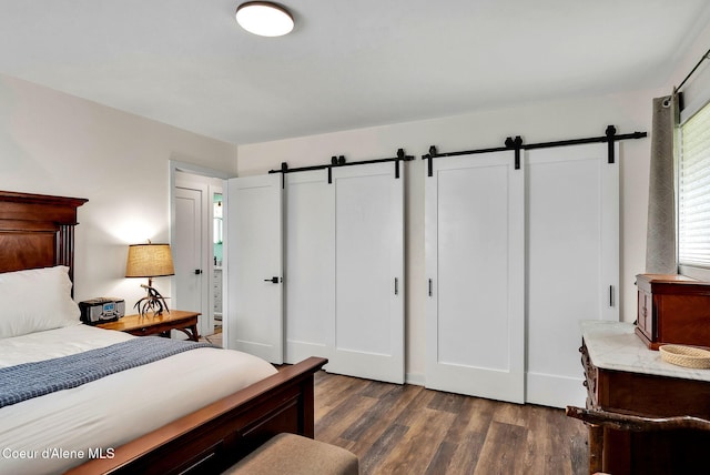 2040 Washington Ave, Saint Maries, ID 83861 - bedroom featuring a barn door and dark wood-style flooring