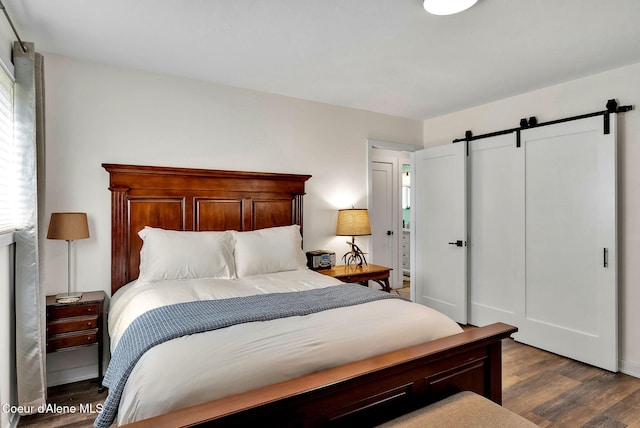 2040 Washington Ave, Saint Maries, ID 83861 - bedroom featuring a barn door and dark wood finished floors