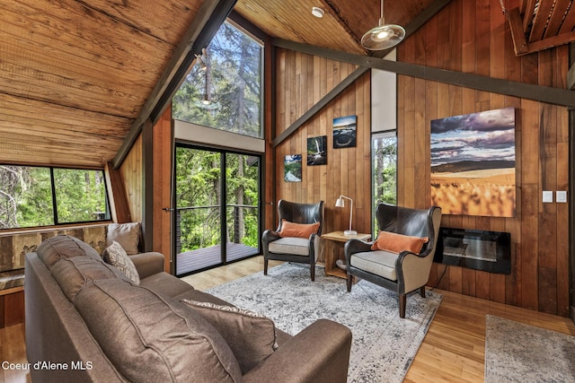 852 Woodland Dr, Sandpoint, ID 83864 - living room with wooden ceiling, wooden walls, high vaulted ceiling, and wood finished floors
