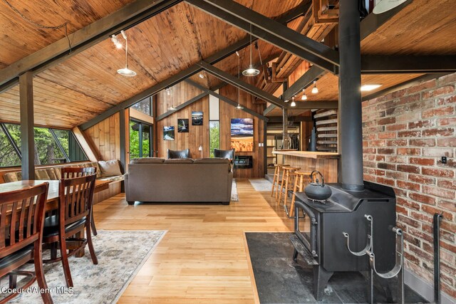 852 Woodland Dr, Sandpoint, ID 83864 - living area featuring a wood stove, wood ceiling, hardwood / wood-style flooring, and wooden walls