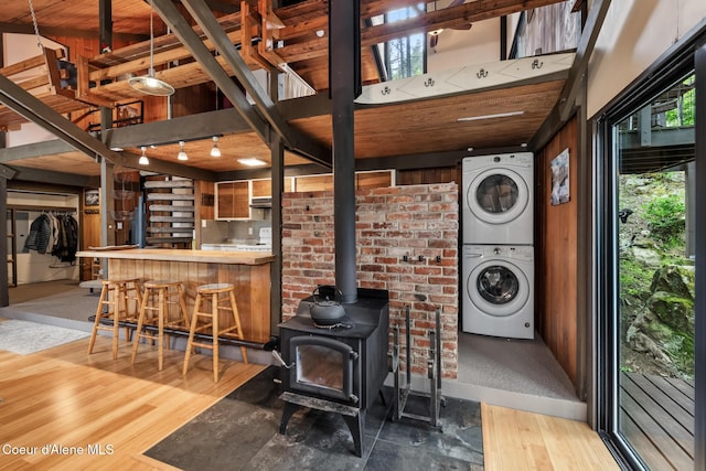 852 Woodland Dr, Sandpoint, ID 83864 - interior space with stacked washer / dryer, wood finished floors, and a wood stove