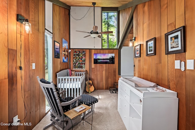 852 Woodland Dr, Sandpoint, ID 83864 - living area with ceiling fan, carpet, wooden walls, and high vaulted ceiling