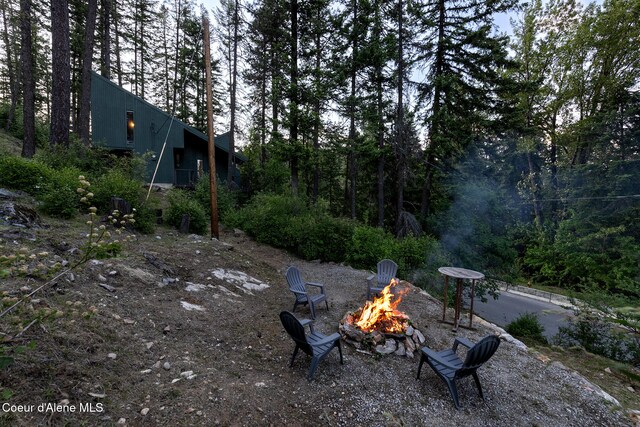 852 Woodland Dr, Sandpoint, ID 83864 - view of yard featuring a fire pit and a view of trees