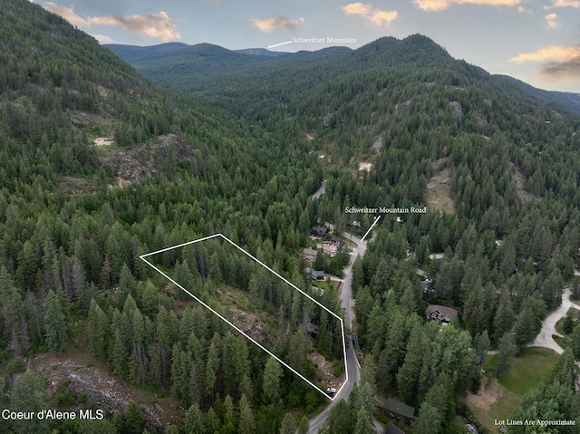 852 Woodland Dr, Sandpoint, ID 83864 - view of property location featuring a heavily wooded area, a mountain backdrop, and property boundaries highlighted