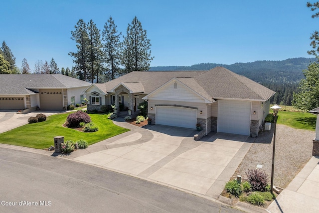 620 N Chisholm Ct, Post Falls, ID 83854 - ranch-style home featuring an attached garage, stone siding, a front yard, and driveway