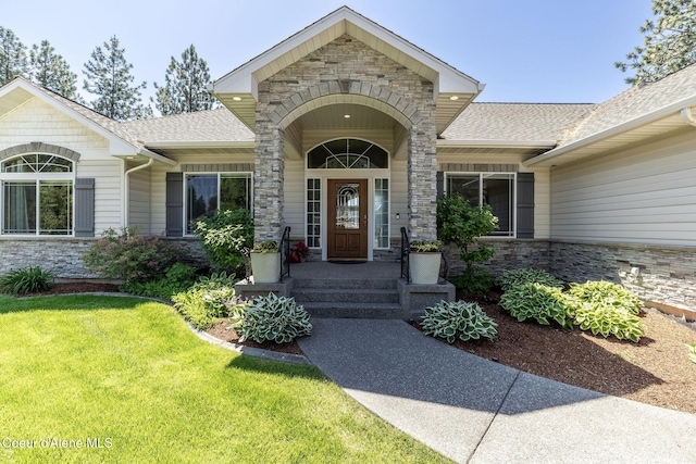620 N Chisholm Ct, Post Falls, ID 83854 - property entrance featuring stone siding, a shingled roof, and a yard