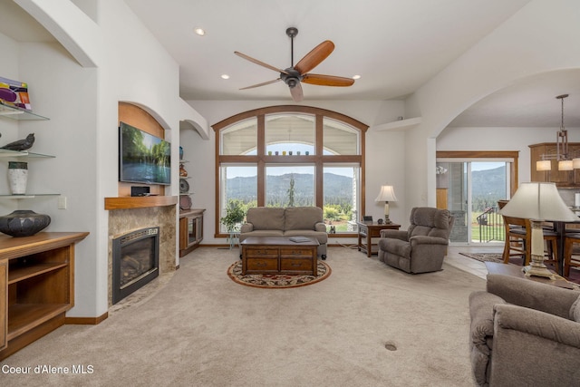 620 N Chisholm Ct, Post Falls, ID 83854 - carpeted living area with arched walkways, a ceiling fan, a fireplace, and recessed lighting