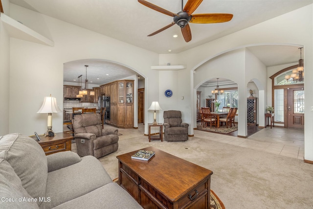 620 N Chisholm Ct, Post Falls, ID 83854 - living room featuring a chandelier, arched walkways, recessed lighting, light carpet, and ceiling fan