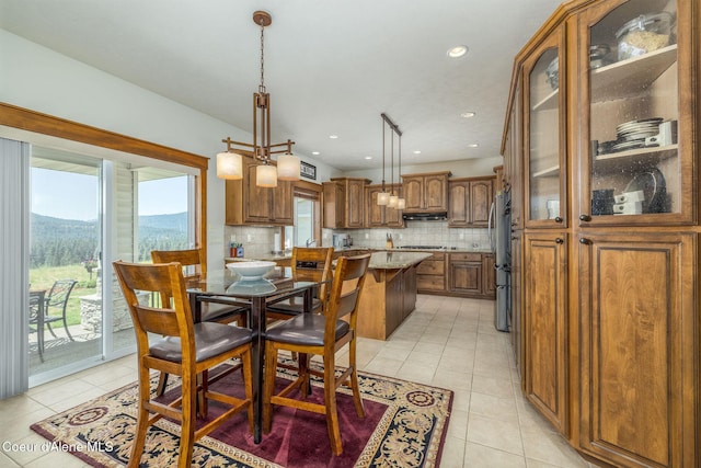 620 N Chisholm Ct, Post Falls, ID 83854 - dining area with light tile patterned floors, healthy amount of natural light, a mountain view, and recessed lighting