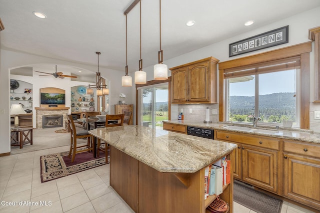 620 N Chisholm Ct, Post Falls, ID 83854 - kitchen featuring a ceiling fan, a kitchen island, light stone countertops, light tile patterned floors, and recessed lighting