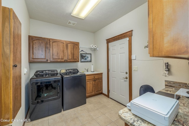 620 N Chisholm Ct, Post Falls, ID 83854 - laundry area with washer and clothes dryer, cabinet space, and light tile patterned flooring