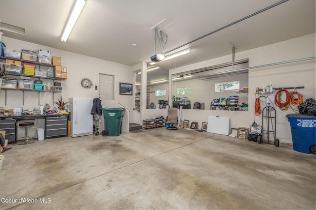 620 N Chisholm Ct, Post Falls, ID 83854 - garage with freestanding refrigerator and a garage door opener