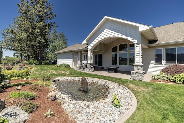620 N Chisholm Ct, Post Falls, ID 83854 - rear view of house with a yard, a patio area, and a shingled roof